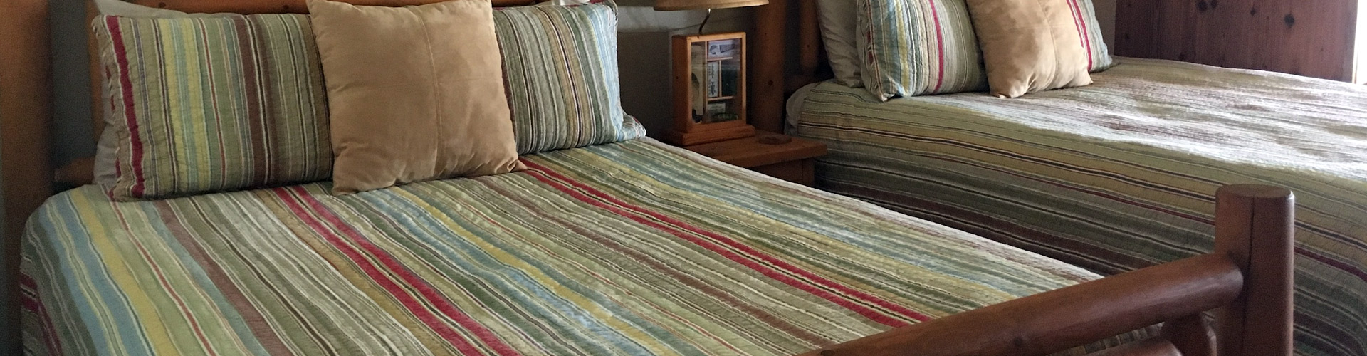 Comfortable Queen Beds in a Waterfront Suite at The Lodge at Whale Pass in Alaska